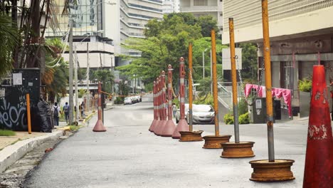 street obstacle barrier cones place over the asphalt to warn the drivers about parking in that spot that is reserved on advanced for parking spaces