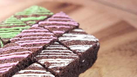 colorful decorated brownies on wooden board