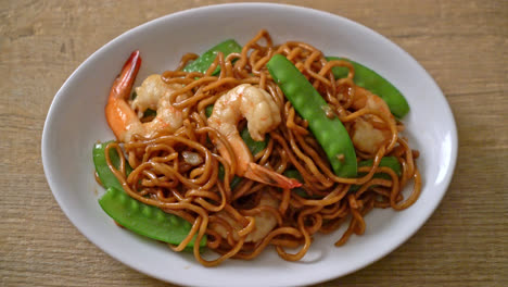 stir-fried yakisoba noodles with green peas and shrimps - asian food style