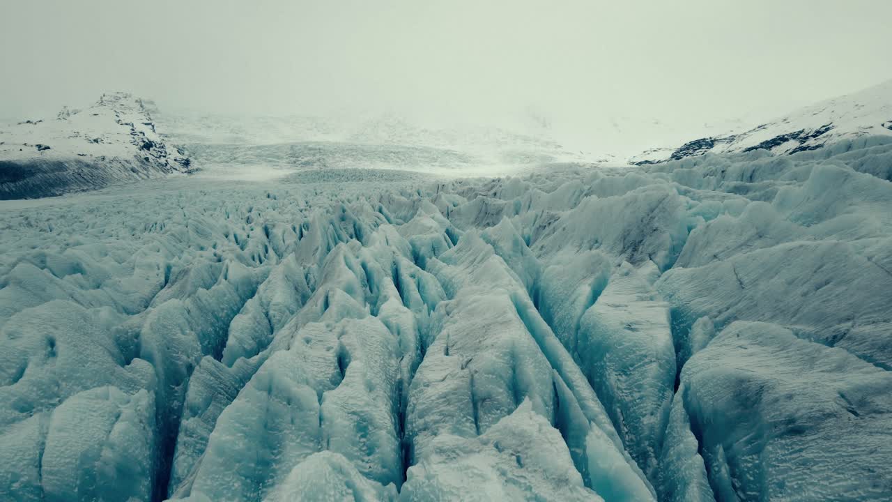 Aerial View of a Vast Glacier with Jagged Ice Formations