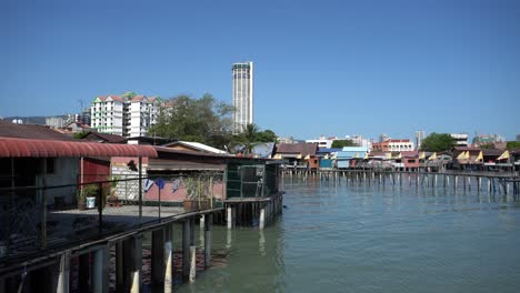 Panning Penang heritage clan house at sea with background KOMTAR
