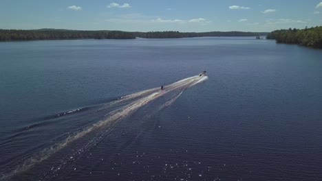 person start to waterski in a lake in the summertime.