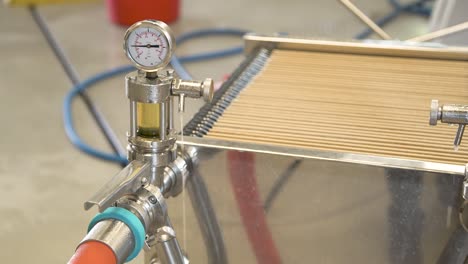 Pressure-gauge-brewery-equipment-dripping-with-condensation-and-beer