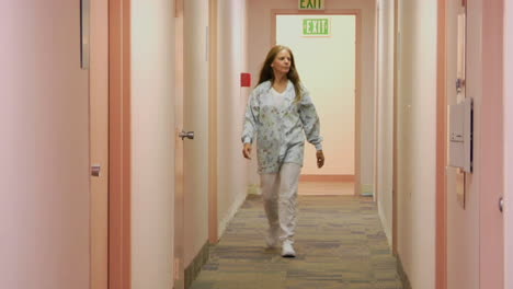 a medical professional walks down the hallway of a medical facility