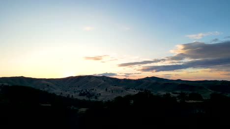 the drone ascends to reveal the sun in the distance near christmas creek in queensland australia