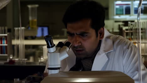 a scientist looking into a microscope in a laboratory