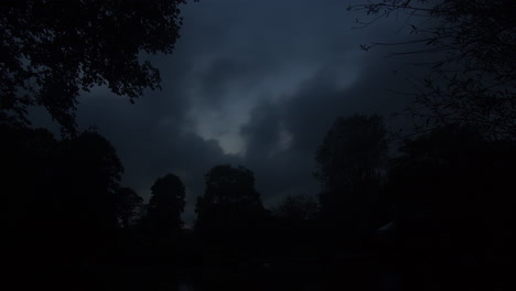 Dark-Gray-Clouds-Moving-Over-Trees-In-Silhouette-On-A-Dramatic-Sunset-In-Autumn