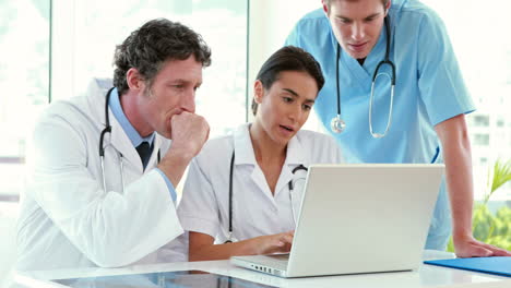 Medical-team-working-on-laptop-computer-