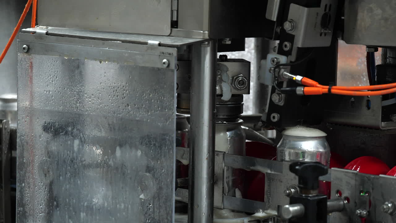 línea de enlatado en cervecería tapando cervezas