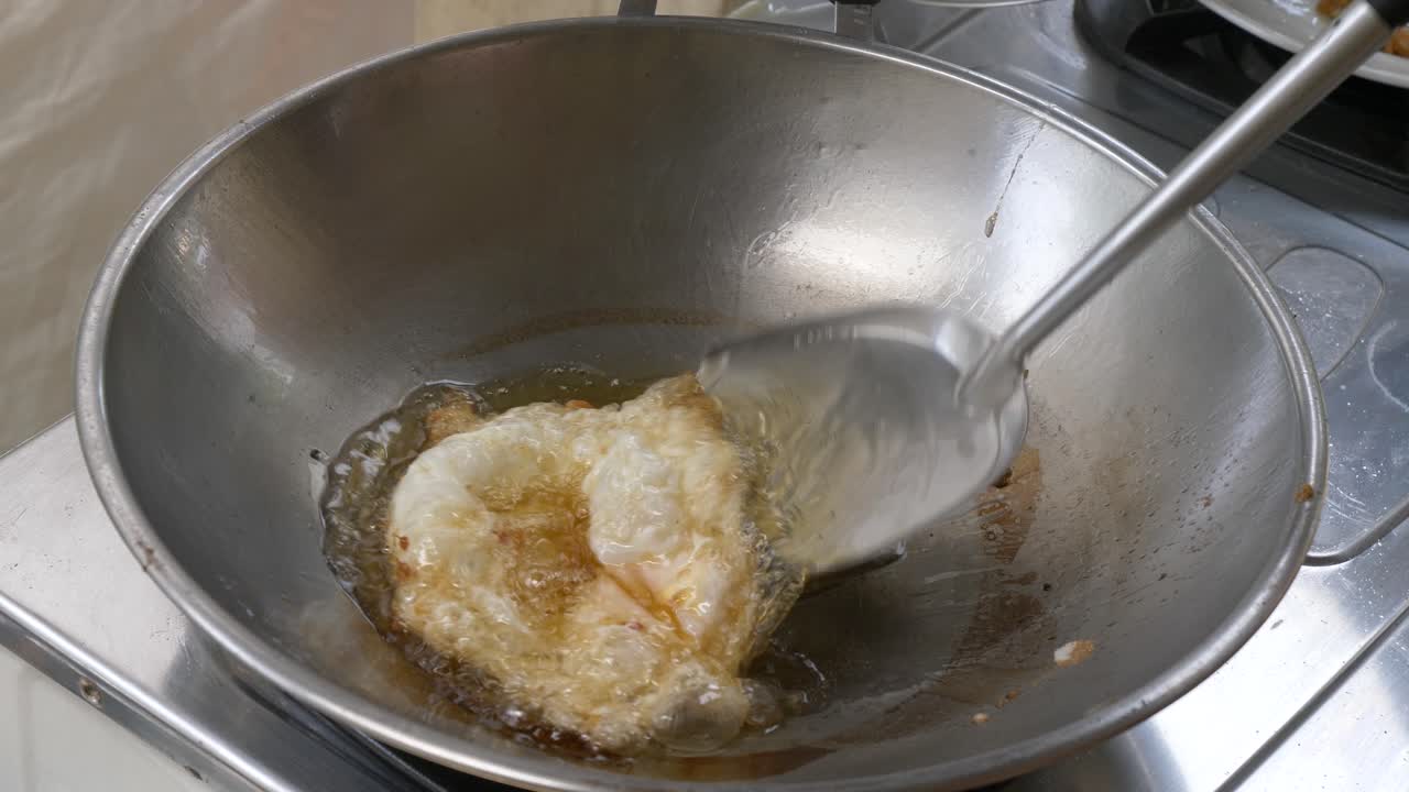 Frying egg in hot pan and  oil. 60FPS