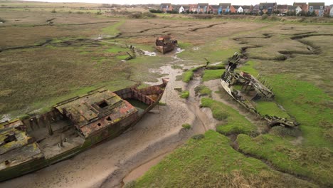 rusting shipwrecks on salt marsh at fleetwood marshes nature reserve