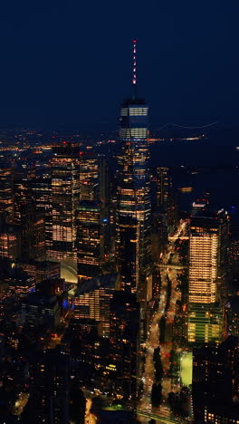 multiple city lights of glamorous new york at night. drone footage rising over the stunning skyscrapers. vertical video