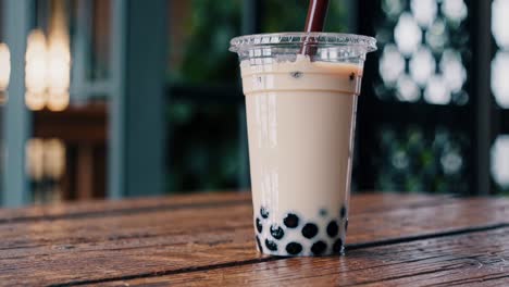 bubble tea in plastic cup on wooden table