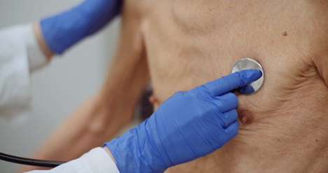 female doctor examine elderly man with stethoscope 3