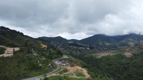 beautiful valley shot revealing looming dark clouds above as the camera flies across the trees