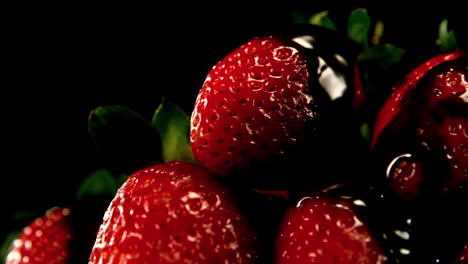 melted chocolate pouring over strawberries