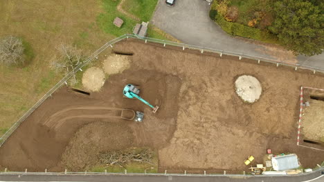 excavator takes soil and move it on tractor