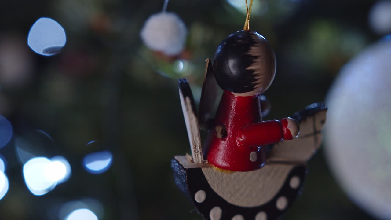 Colorful Toy Decoration Rotating on Green Christmas Tree Close Up 4K