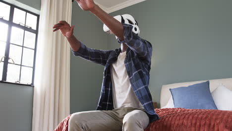 man using vr headset in bedroom, exploring virtual reality experience