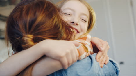 rear of the mother and her cute daughter running to her and hugging tight. a home. close up. portrait. indoor