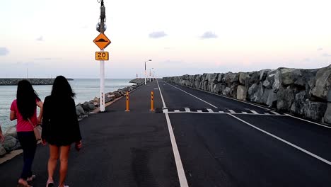 Three-Females-walking-on-a-wharf