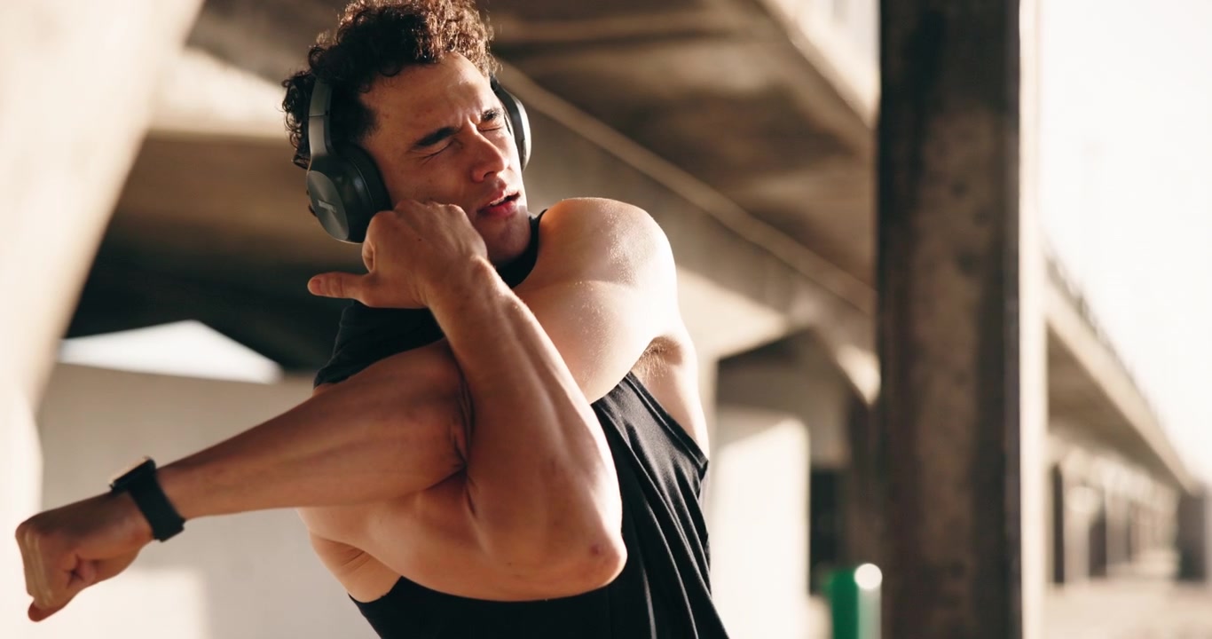 Young Man Stretching Arms After Workout Outdoors