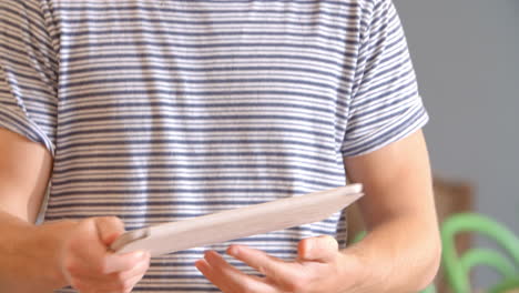 man follows recipe on digital tablet in kitchen shot on r3d