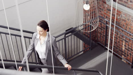 pretty businesswoman climbing the stairs