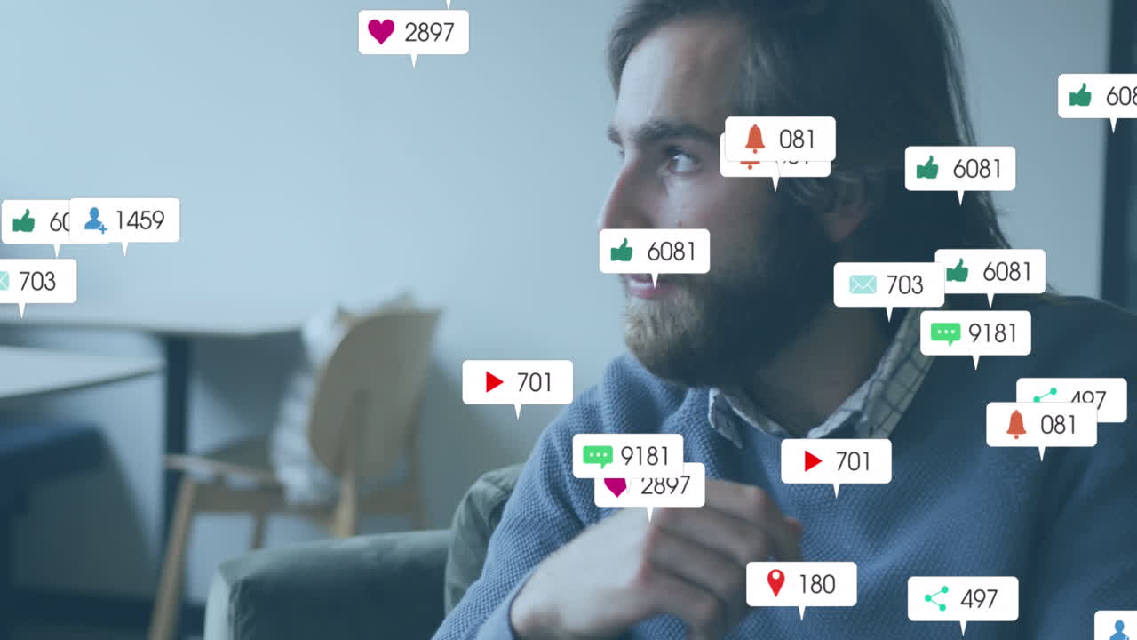 Animation of social media icons against thoughtful caucasian man sitting at office