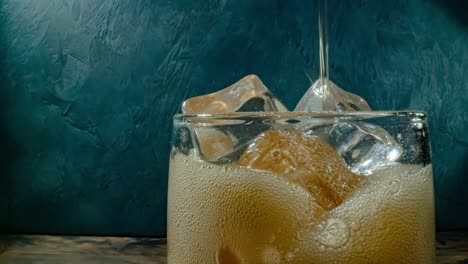 cola with ice and bubbles in glass.