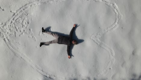 the man making a heart in the snow