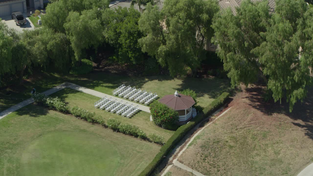 Wedding Ceremony Setup On Golf Course in California - Aerial Reveal From Trees