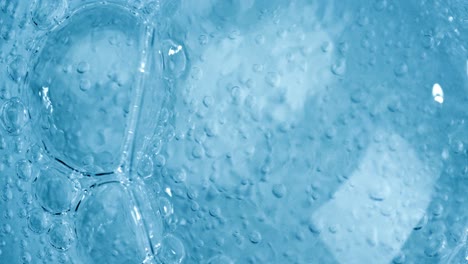 oxygen bubbles in water on a blue abstract background on super slow motion.