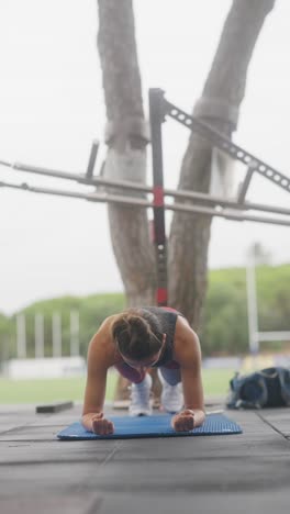 woman performing a plank exercise outdoors