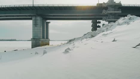 trucks drive along huge bridge near old rusty pier upper