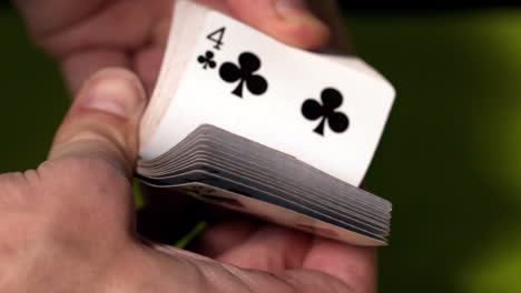 hand flicking through deck of cards