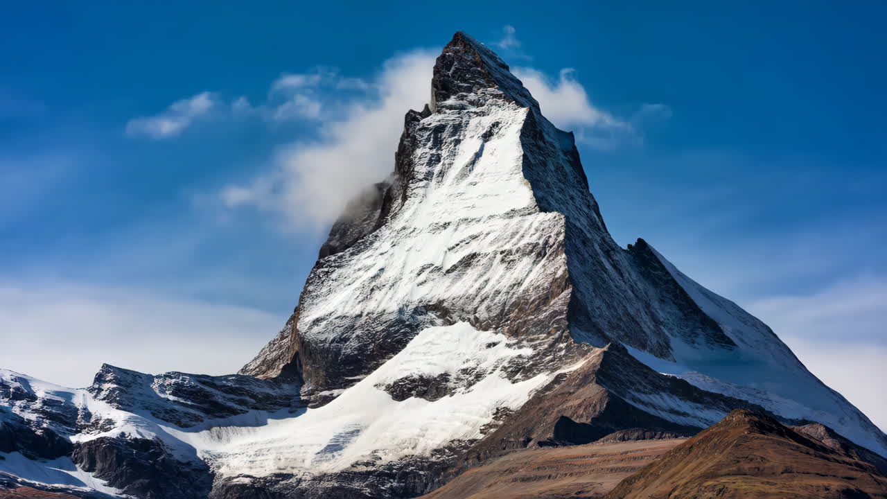 Majestic Snow-Capped Mountain Peak with Dramatic Clouds