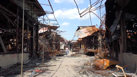 A-Woman-Walks-Through-A-Shopping-Center-Destroyed-And-Burned-Following-A-Russian-Missile-Attack-On-The-City-Of-Kharkiv,-Ukraine