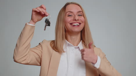 businesswoman real estate agent showing the keys of new home house apartment renting buying property