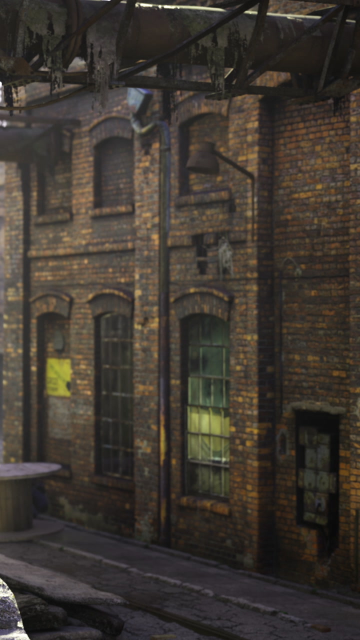 Old brick building in a narrow alley with a large industrial structure above