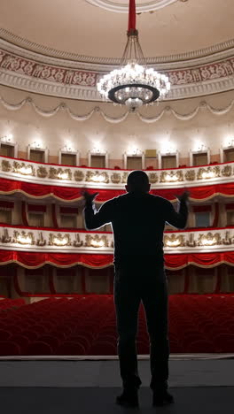 empty theatre auditorium cinema or conference hall. actor on stage in front of empty chairs. vertical video