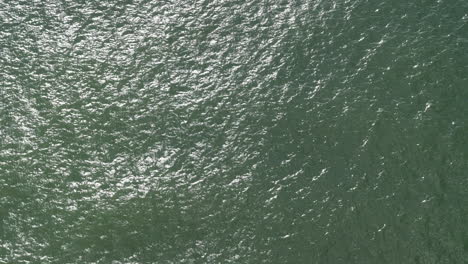 shimmering river water surface view from above, complete frame fill