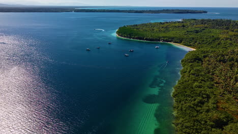 aerial view of lush green island with clear turquoise sea - bocas del toro, isla colon, panama.