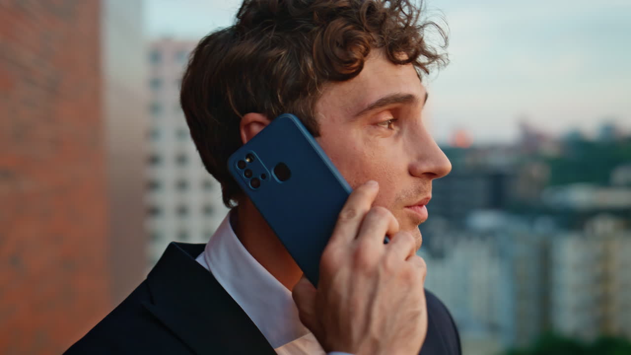 Rich businessman speaking smartphone at office balcony closeup. Man calling