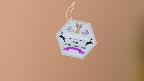 animation of christmas greetings on tag over beige background