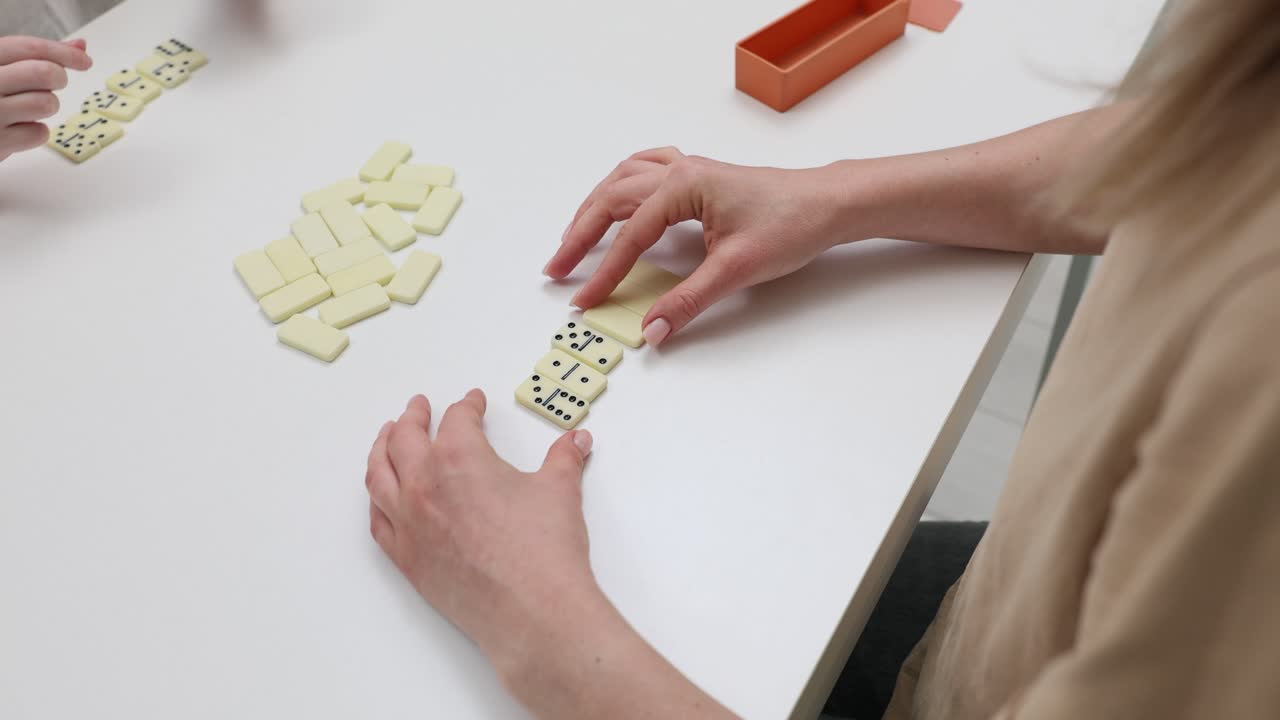 Playing dominoes on a table