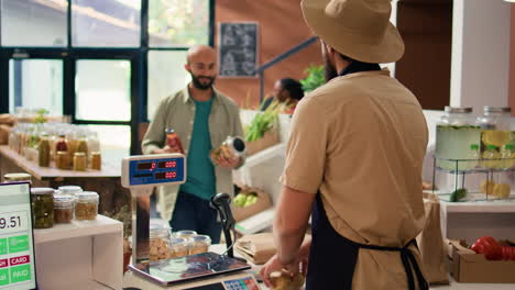 Man-checking-weight-of-produce