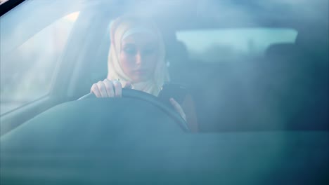 woman driving a car and using mobile phone