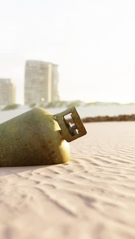 rusty tank on a beach at sunset