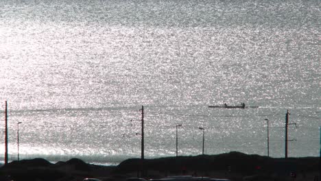 Kayaks-rowing-along-the-coast-at-morning